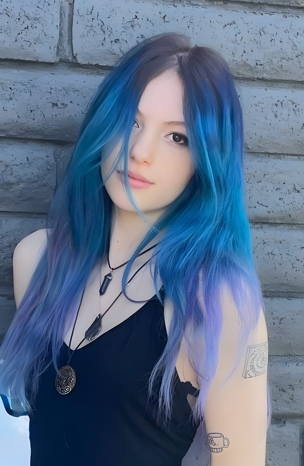 Long hair colored in blue and purple, against a brick wall